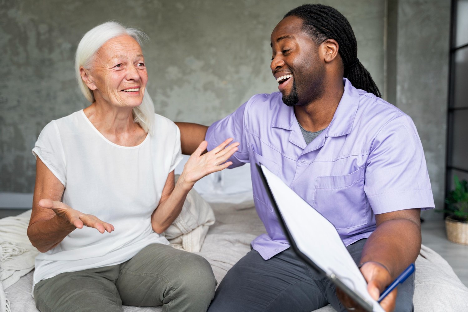 Caregiver and client sharing tea and conversation at home