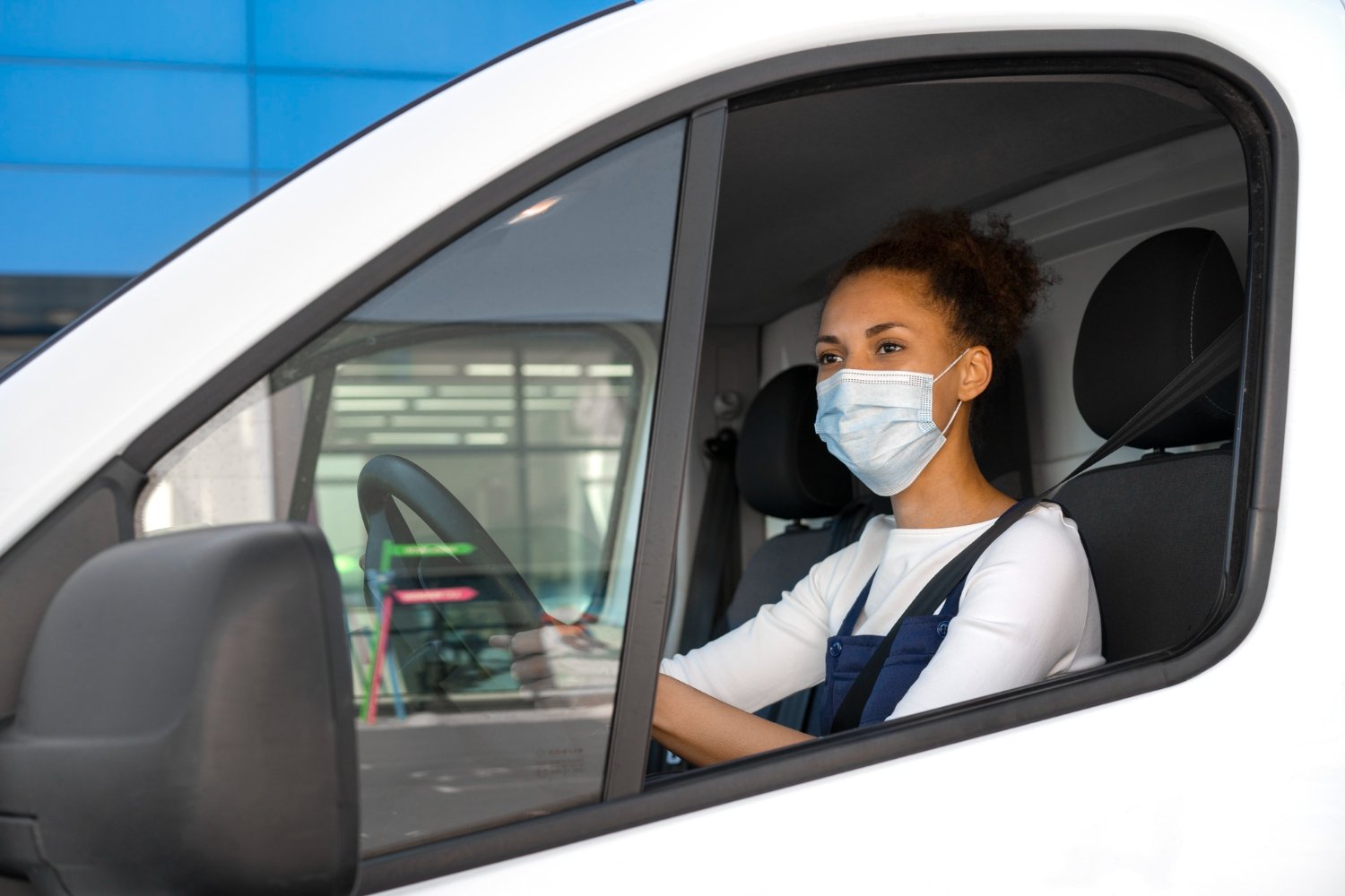 Caregiver helping a client into a car for an appointment
