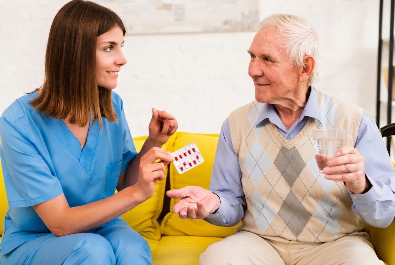 Caregiver reviewing a medication schedule with a client at the kitchen table